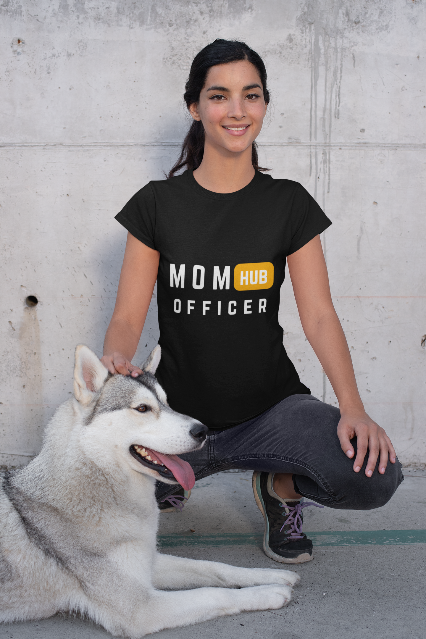 Mom Hub Officer” mom shirts style tee worn by smiling woman kneeling beside her husky outdoors.