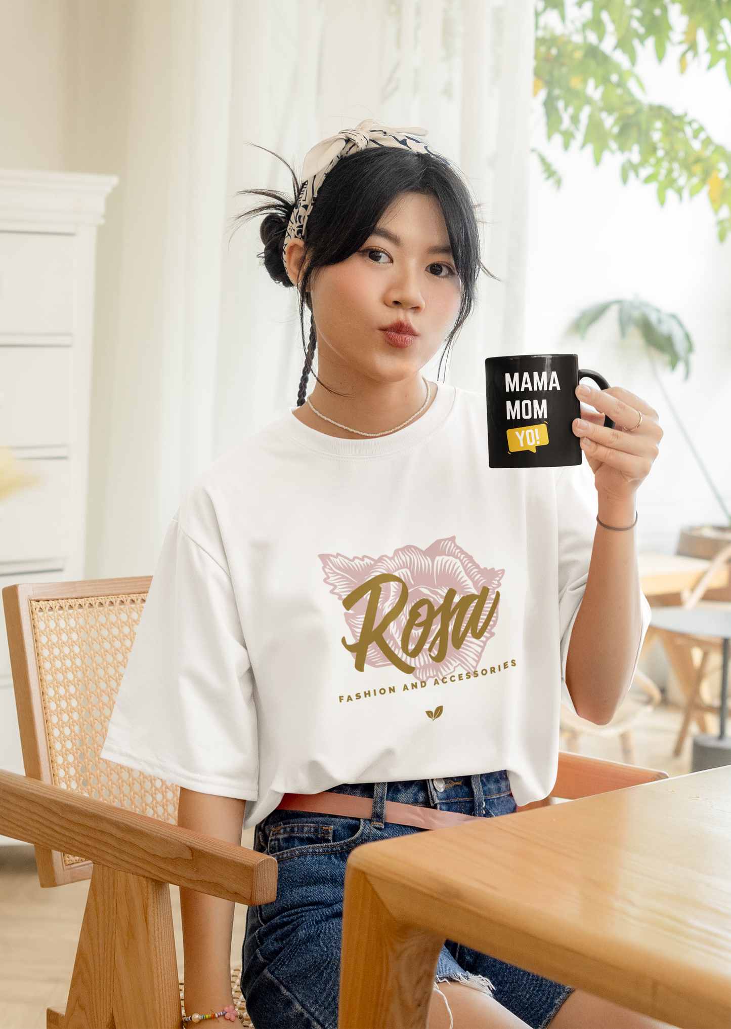 Young woman holding black ceramic mug with bold “Mama Mom Yo!” design, smiling and relaxed at home, celebrating modern motherhood.