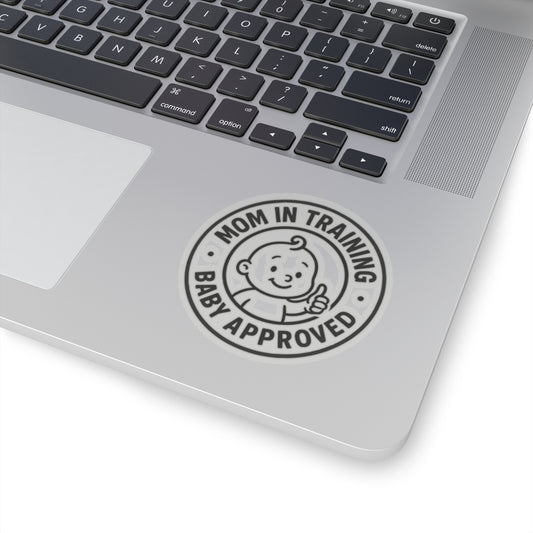 Funny Gifts “Mom in Training – Baby Approved” vinyl sticker on laptop palm rest—bubble‑free vinyl decal for new‑mom tech accessories.

