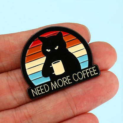 Hand holding Need More Coffee cat brooch pin—retro rainbow enamel brooch for coffee lovers.