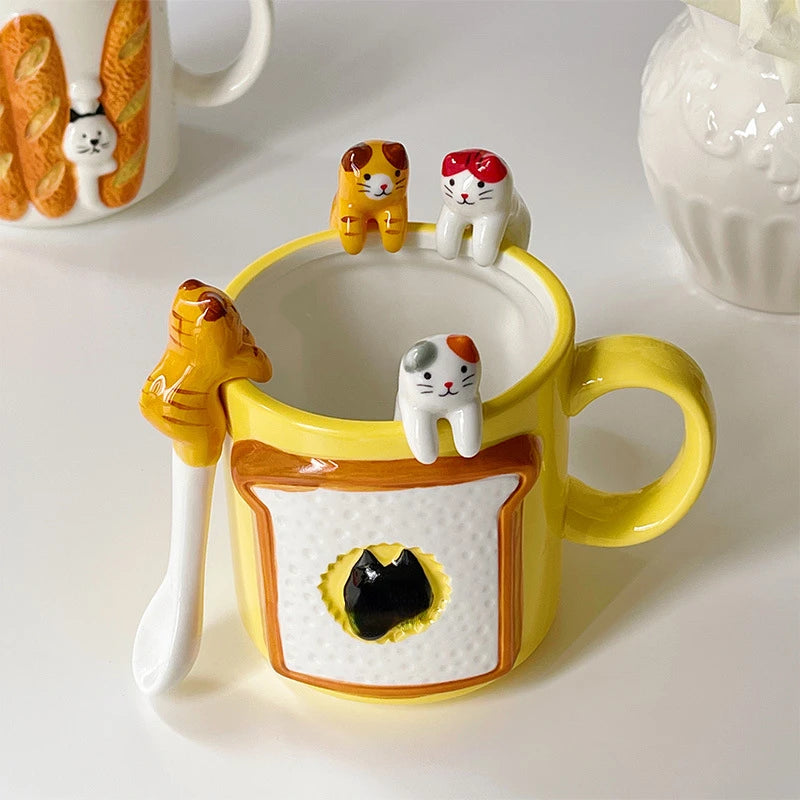 Yellow mug scene featuring three rim‑sitting cat coffee spoons and a matching hanging coffee spoon—playful tabletop funny gifts idea.


