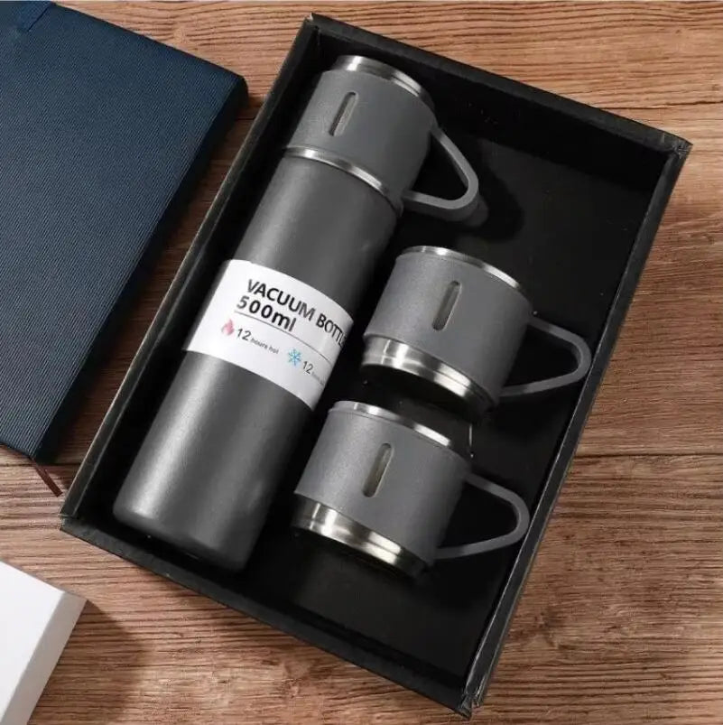 Charcoal grey vacuum bottle tumbler cups set with two stainless‑steel cups presented in sleek presentation box.