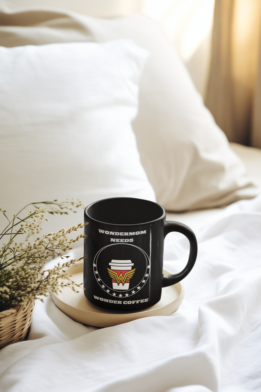 Jet-black ceramic mug with “WonderMom Needs Wonder Coffee” design placed on a bed tray, perfect for Mother’s Day morning coffee in bed.